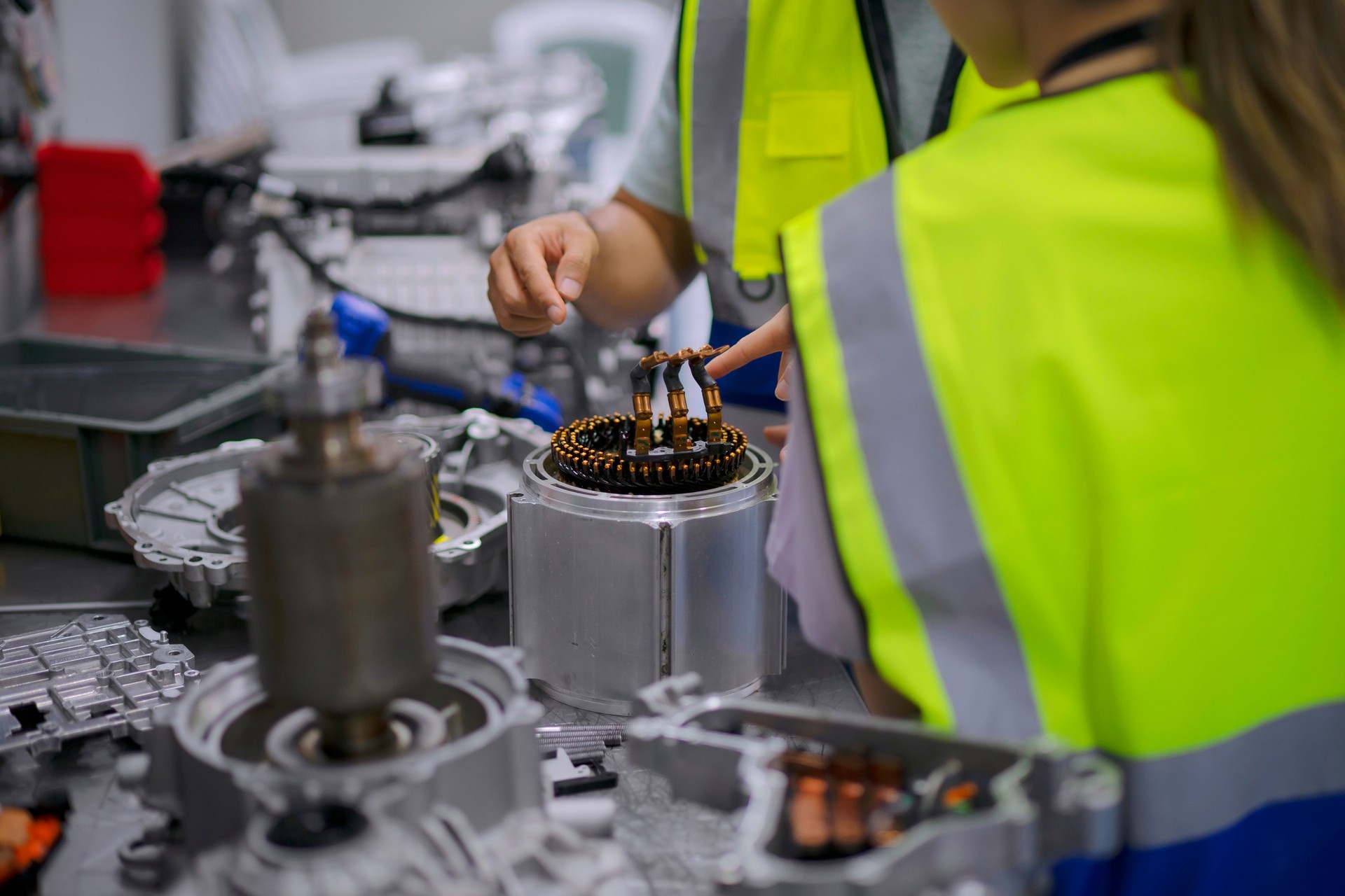 Mechanics are working at EV car workshop.